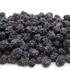 Close-up of plump, dark purple dries aronia berries